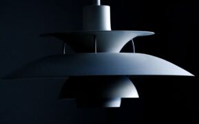Stylish modern pendant lamp with a sleek minimalist design in a dark setting. - Photo by Ludvig Hedenborg on Pexels