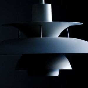 Stylish modern pendant lamp with a sleek minimalist design in a dark setting. - Photo by Ludvig Hedenborg on Pexels