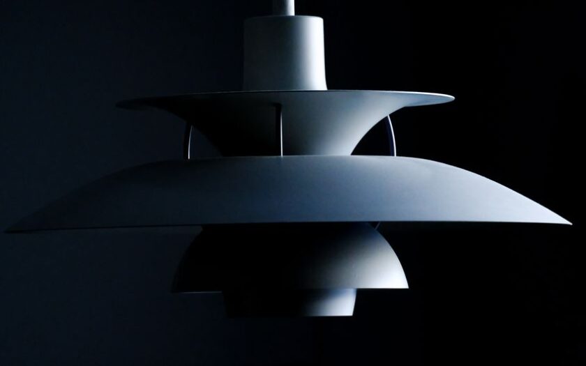 Stylish modern pendant lamp with a sleek minimalist design in a dark setting. - Photo by Ludvig Hedenborg on Pexels