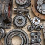 Detailed shot of industrial gears and mechanical parts in a workshop setting. - Photo by Connor Lucock on Pexels