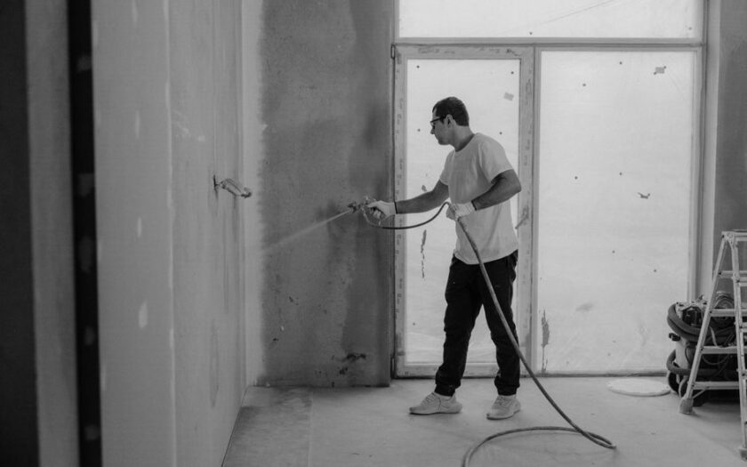 A worker paints an interior wall with a spray gun during a renovation project. - Photo by Tima Miroshnichenko on Pexels